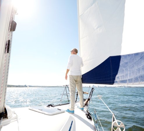 Senior man on sail boat or yacht sailing in sea